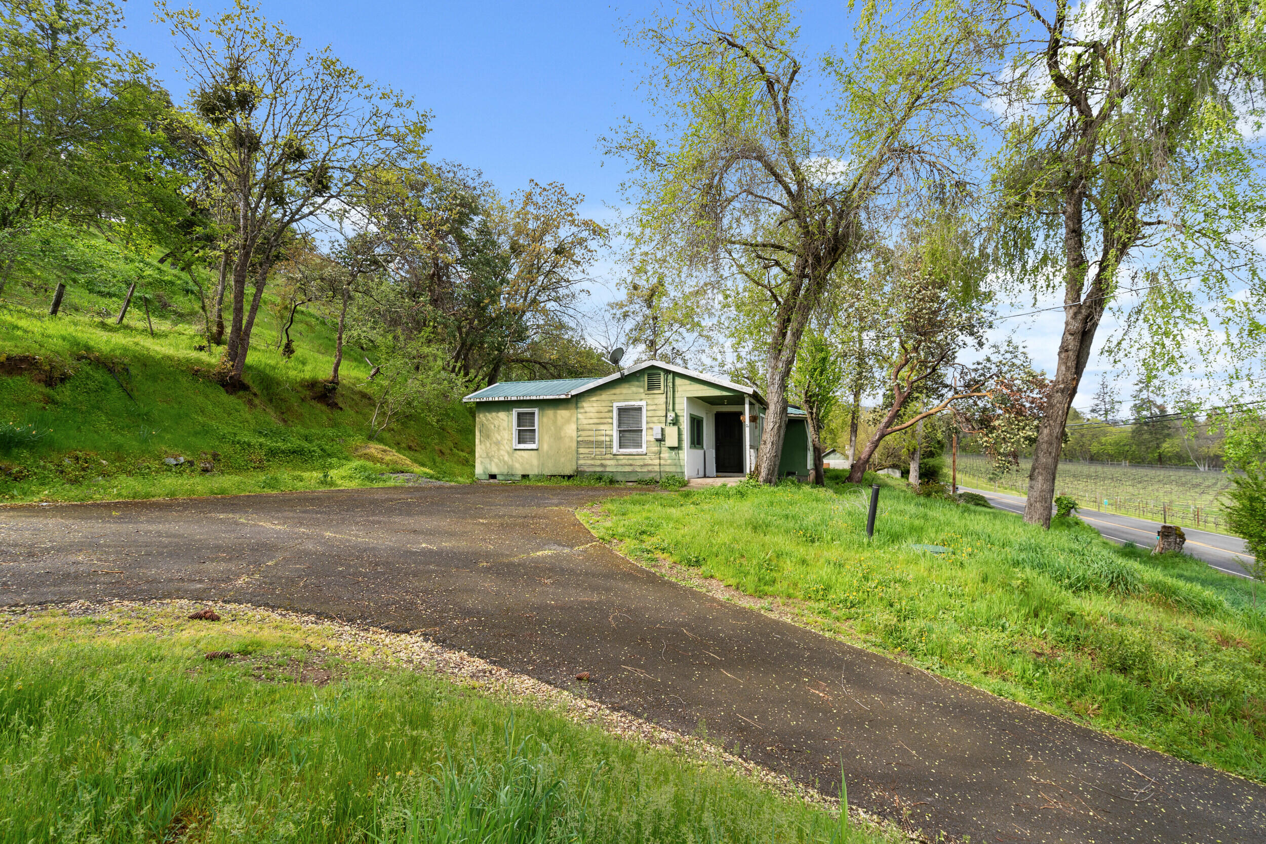 2373 Pioneer Road Talent, OR 97540 - Photo 8 of 28 a front view of a house with a yard and an trees