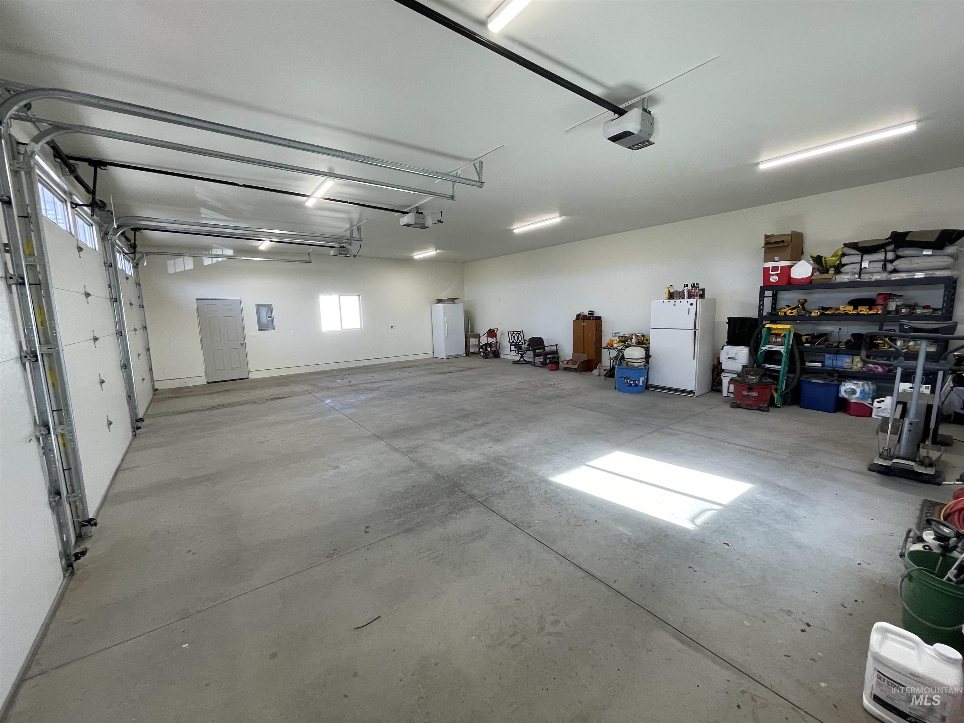 2155 East 1775 South Gooding, ID 83330 - Photo 14 of 18 Garage with freestanding refrigerator and a garage door opener