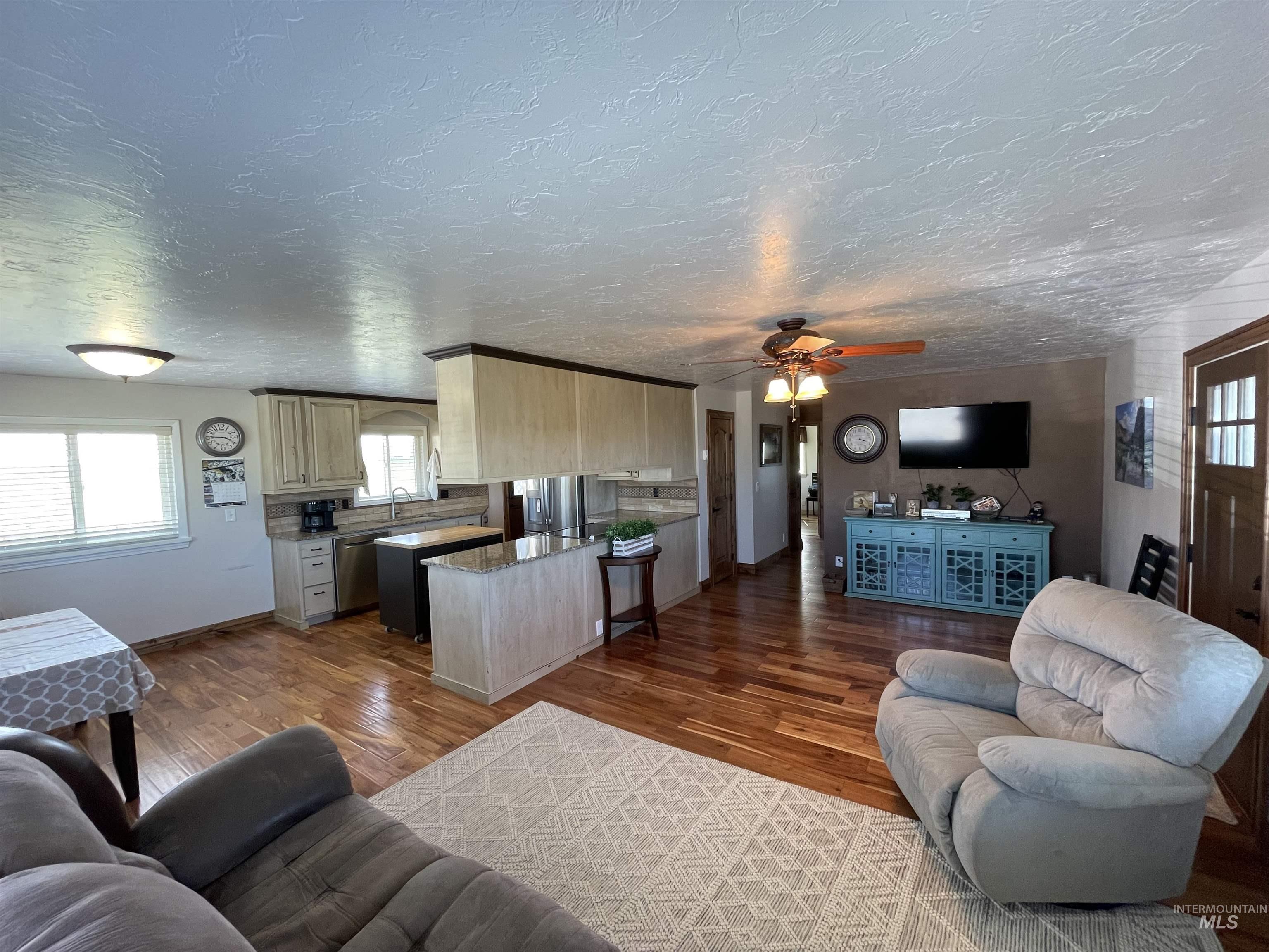 2155 East 1775 South Gooding, ID 83330 - Photo 2 of 18 Living room with dark wood-style floors, ceiling fan, and a textured ceiling