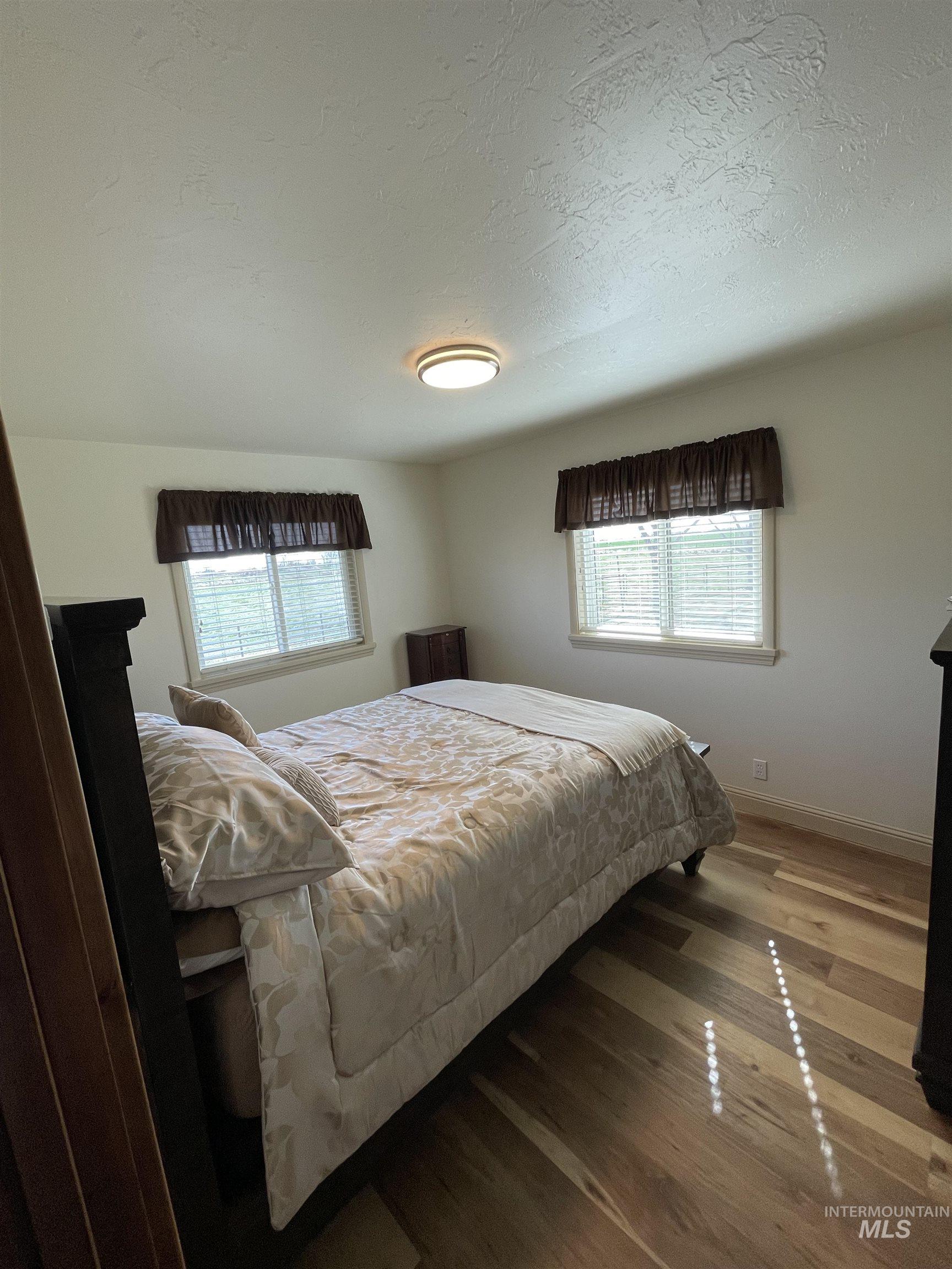 2155 East 1775 South Gooding, ID 83330 - Photo 7 of 18 Bedroom featuring wood finished floors and a textured ceiling