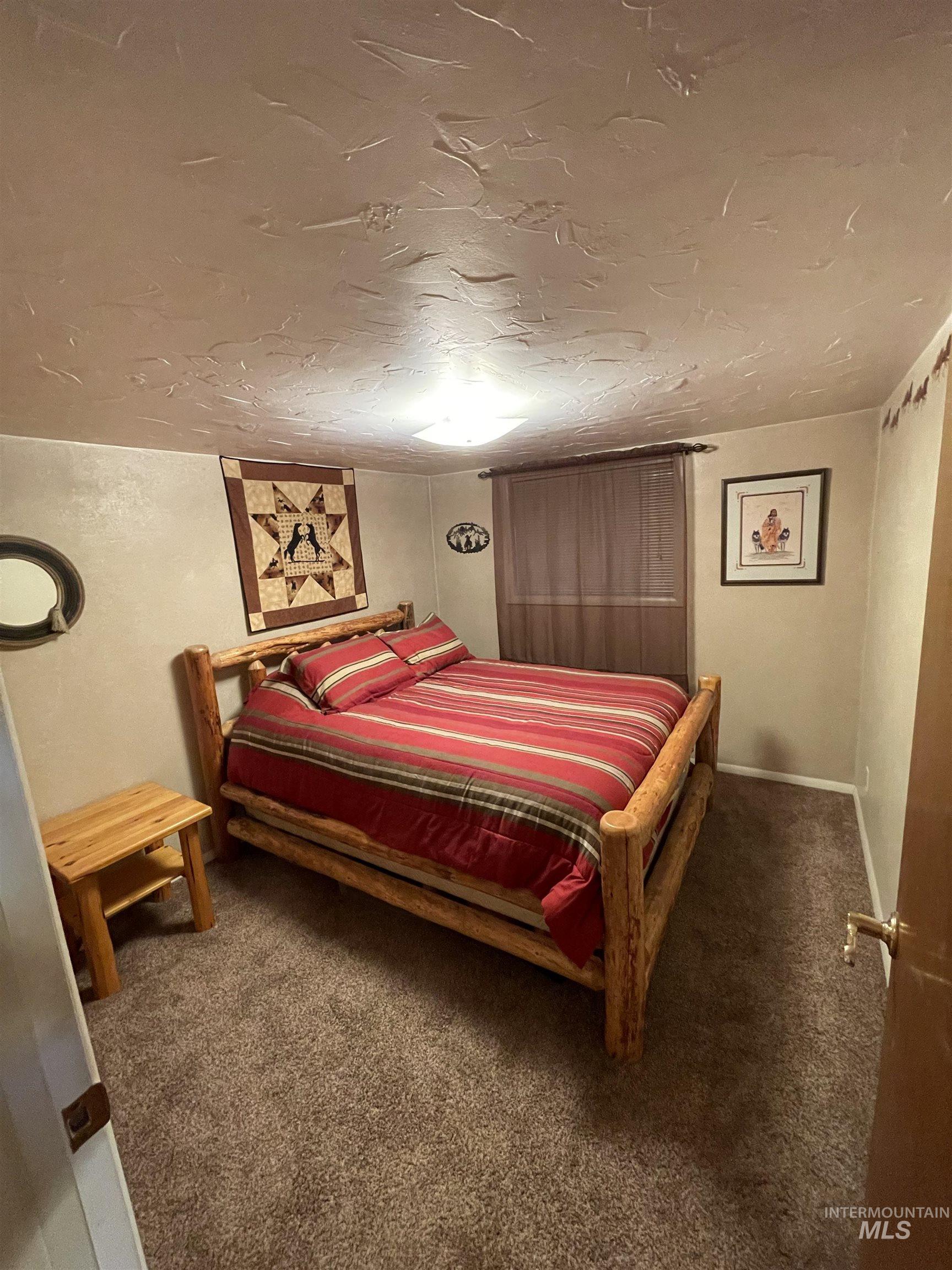 2155 East 1775 South Gooding, ID 83330 - Photo 10 of 18 Bedroom featuring dark carpet and a textured ceiling