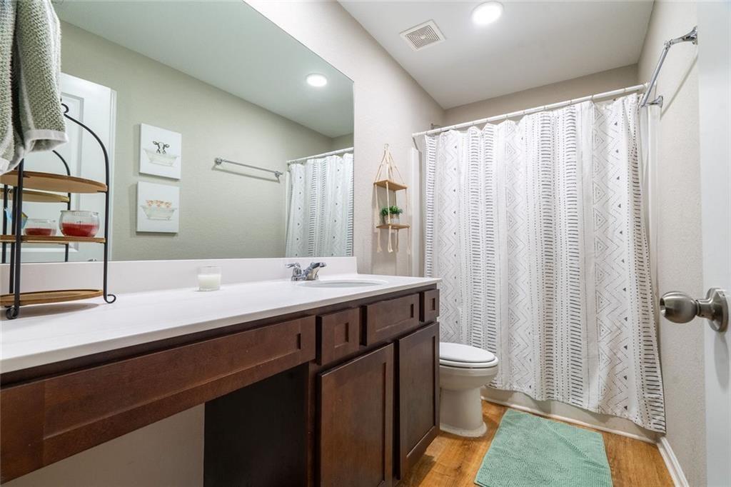 735 Walnut Creek Circle Pendergrass, GA 30567 - Photo 16 of 29 a bathroom with a double vanity sink toilet and a mirror