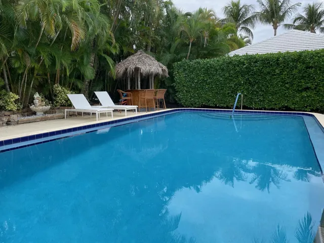 a view of a swimming pool and lounge chairs