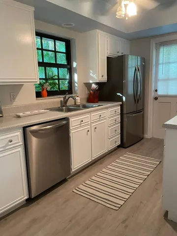 a kitchen with a sink stove and refrigerator