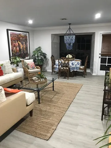 a living room with furniture and a chandelier
