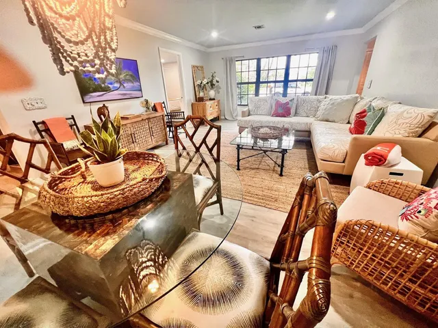 a living room with furniture and a floor to ceiling window
