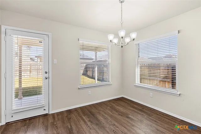a kitchen with stainless steel appliances a sink cabinets and wooden floor