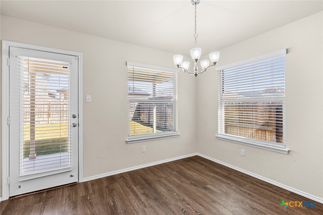 256 Bainbridge Road Temple, TX 76502 - Photo 17 of 40 a view of an empty room with wooden floor and a window