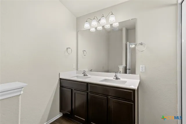 a bathroom with a sink double vanity and a mirror