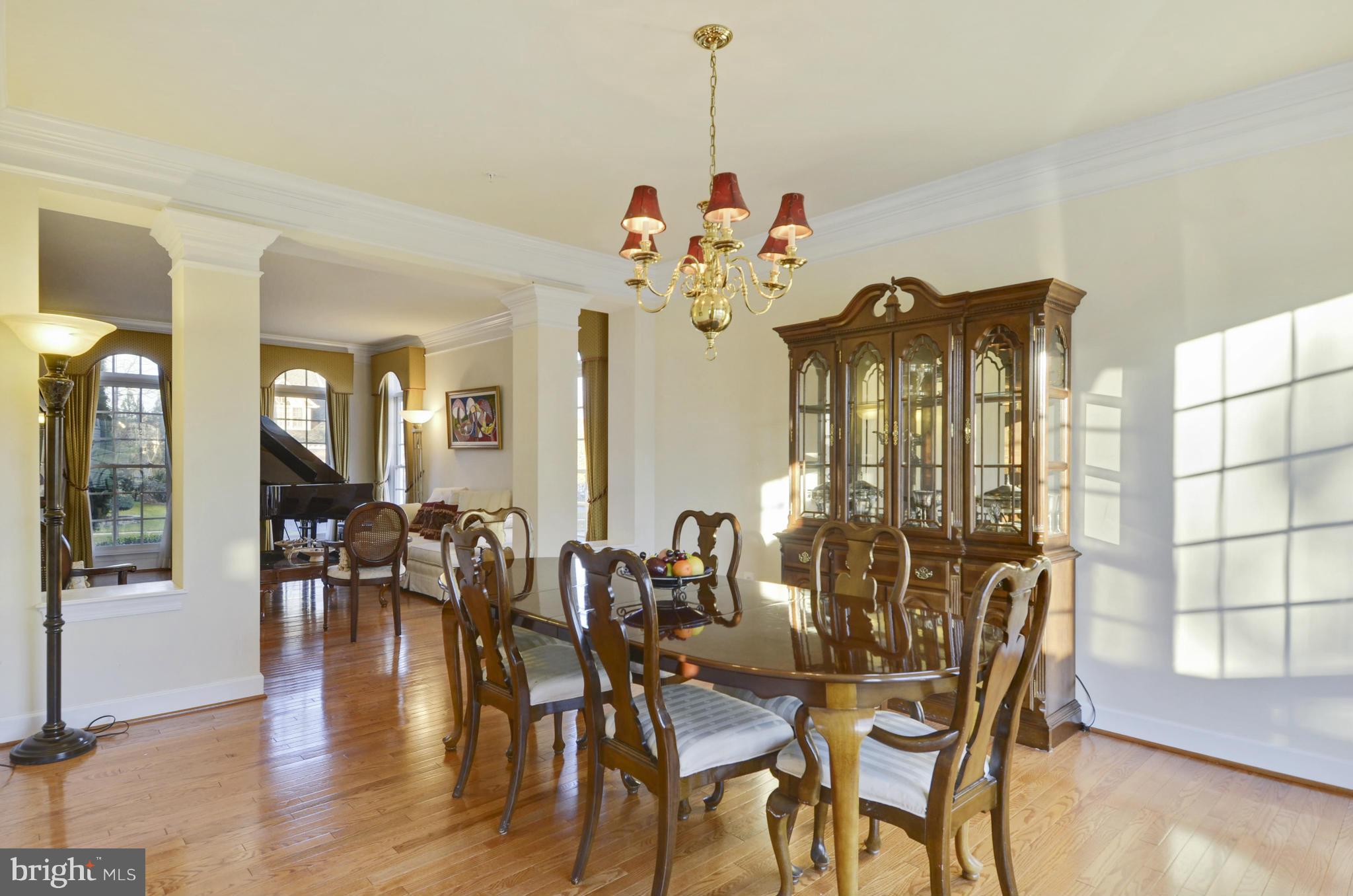 14402 Autumn Rust Road Boyds, MD 20841 - Photo 8 of 30 a view of a dining room with furniture wooden floor and chandelier
