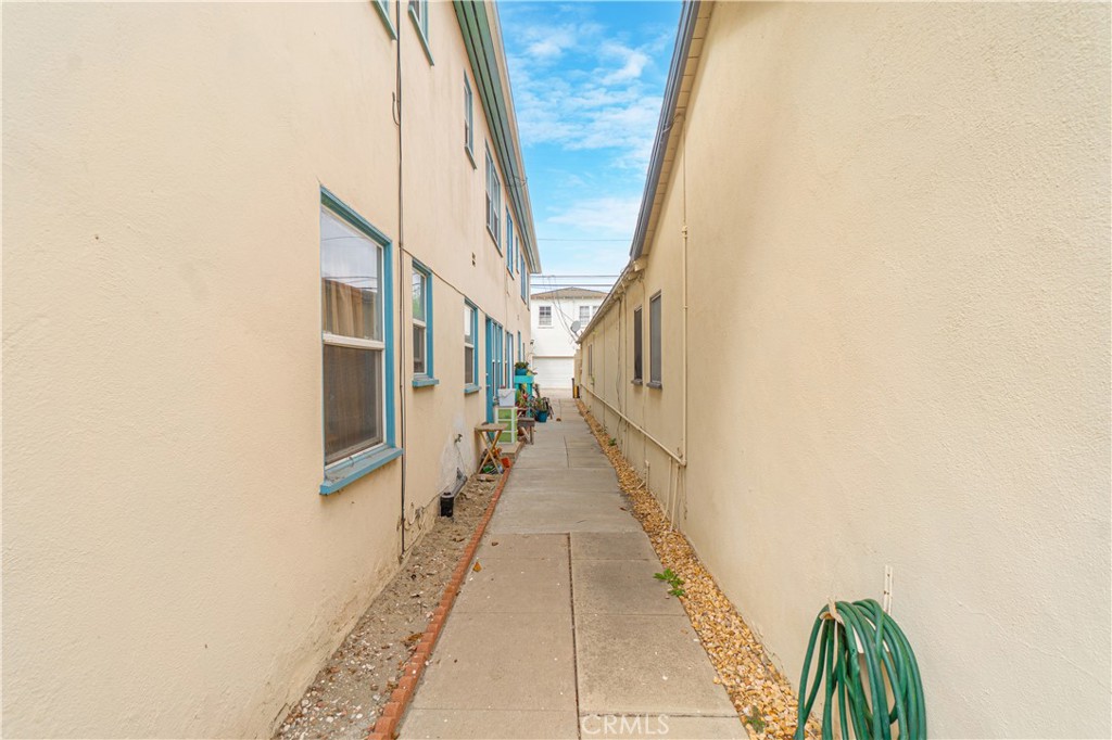 75 Granada Avenue Long Beach, CA 90803 - Photo 8 of 12 a hallway with a white door and wooden floor