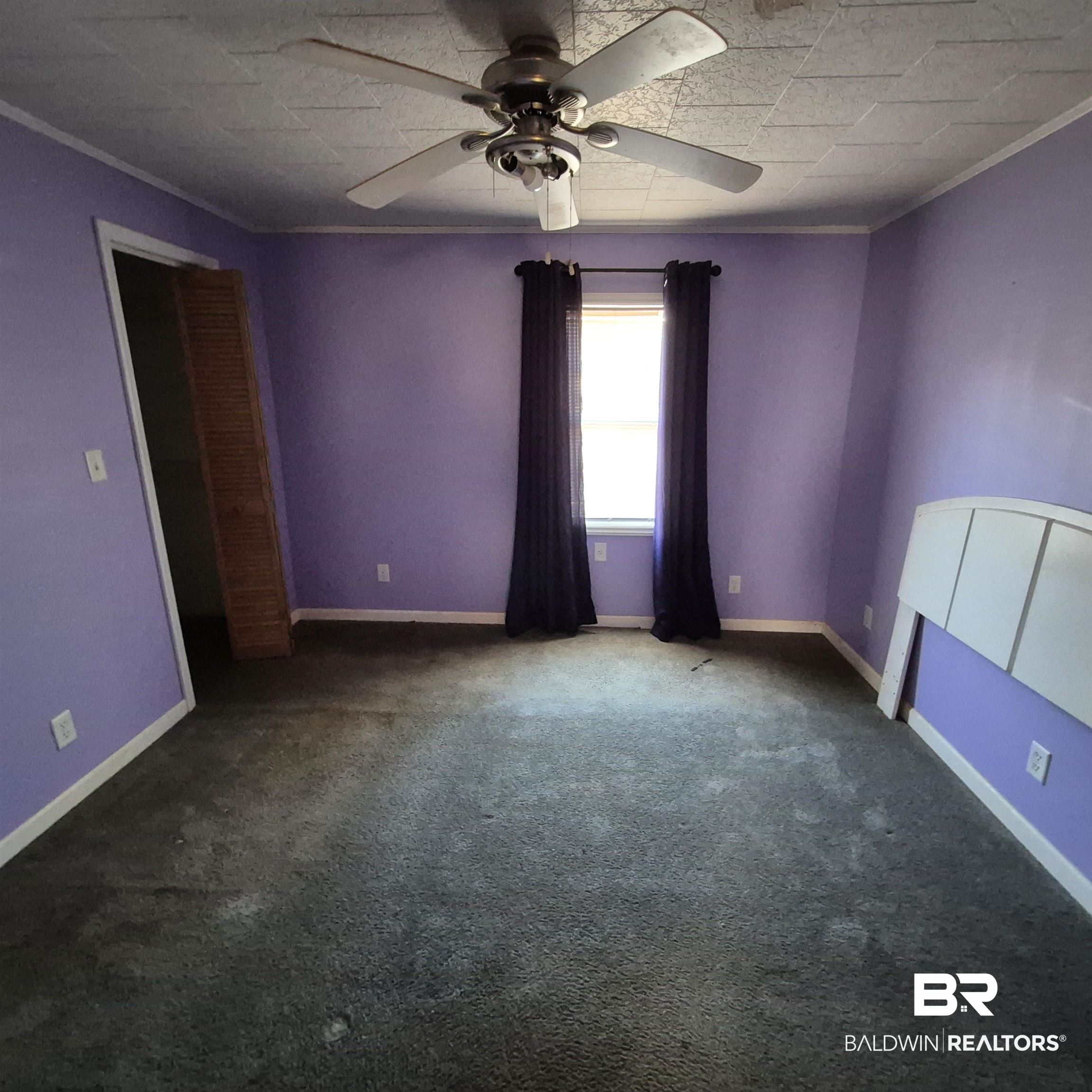 320 Bruner Avenue Evergreen, AL 36401 - Photo 3 of 15 Unfurnished room with a ceiling fan, ornamental molding, and carpet floors
