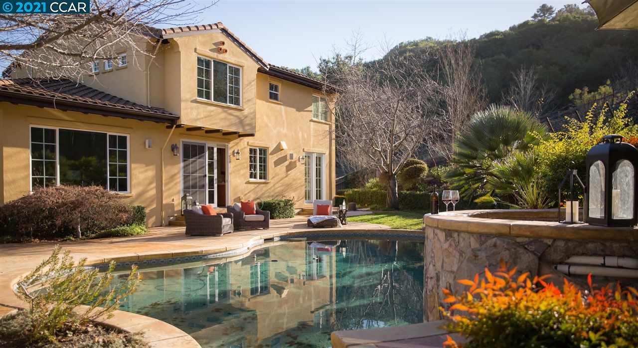 a patio with table and chairs and potted plants