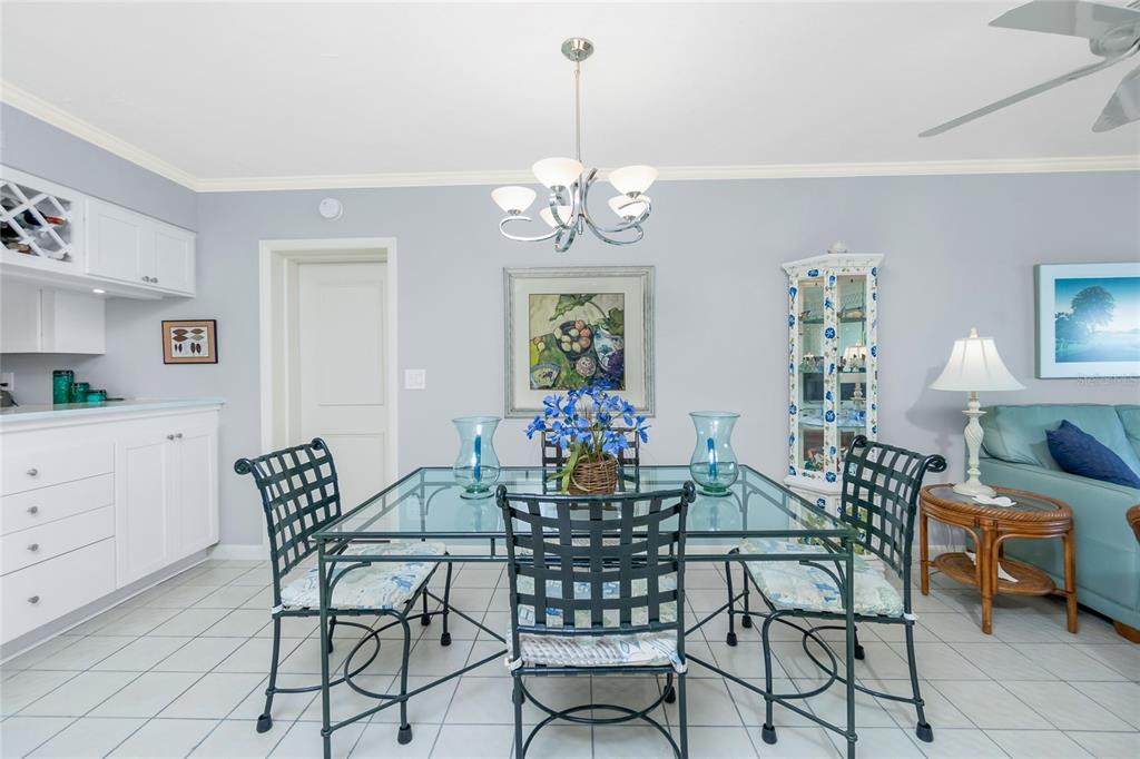 1651 Beach Road, Unit 301 Englewood, FL 34223 - Photo 15 of 68 a view of a dining room with furniture and chandelier