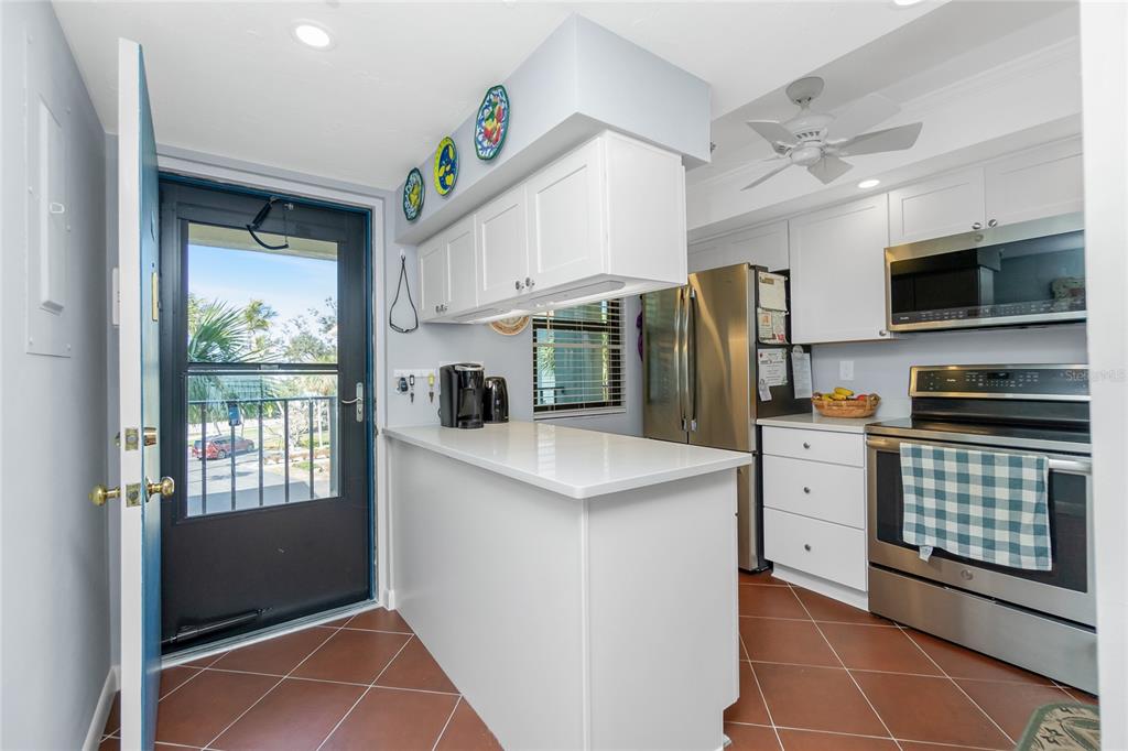 1651 Beach Road, Unit 301 Englewood, FL 34223 - Photo 17 of 68 a kitchen with stainless steel appliances a refrigerator sink and microwave