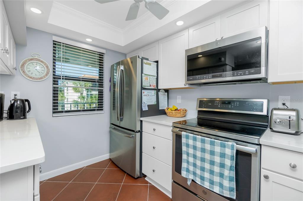 1651 Beach Road, Unit 301 Englewood, FL 34223 - Photo 18 of 68 a kitchen with stainless steel appliances a stove microwave and refrigerator