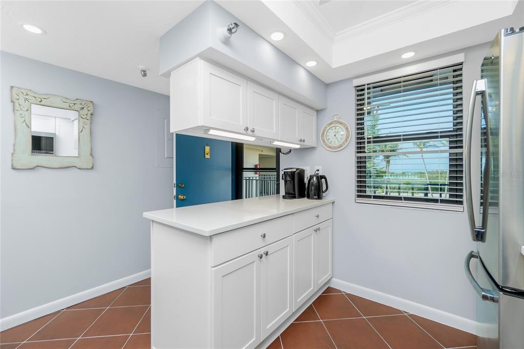 1651 Beach Road, Unit 301 Englewood, FL 34223 - Photo 20 of 68 a kitchen with a sink cabinets and window