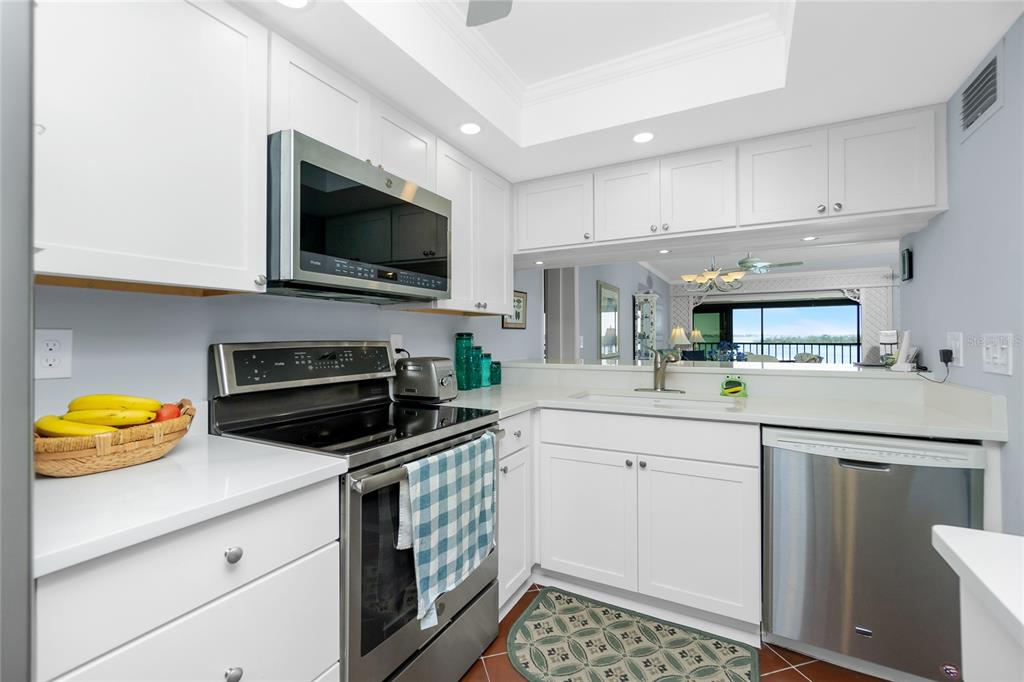 1651 Beach Road, Unit 301 Englewood, FL 34223 - Photo 21 of 68 a kitchen with stainless steel appliances a stove cabinets and a sink