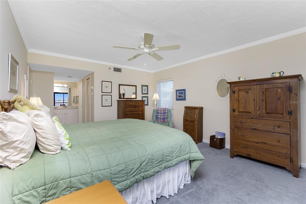 1651 Beach Road, Unit 301 Englewood, FL 34223 - Photo 23 of 68 a bedroom with a bed and a dresser