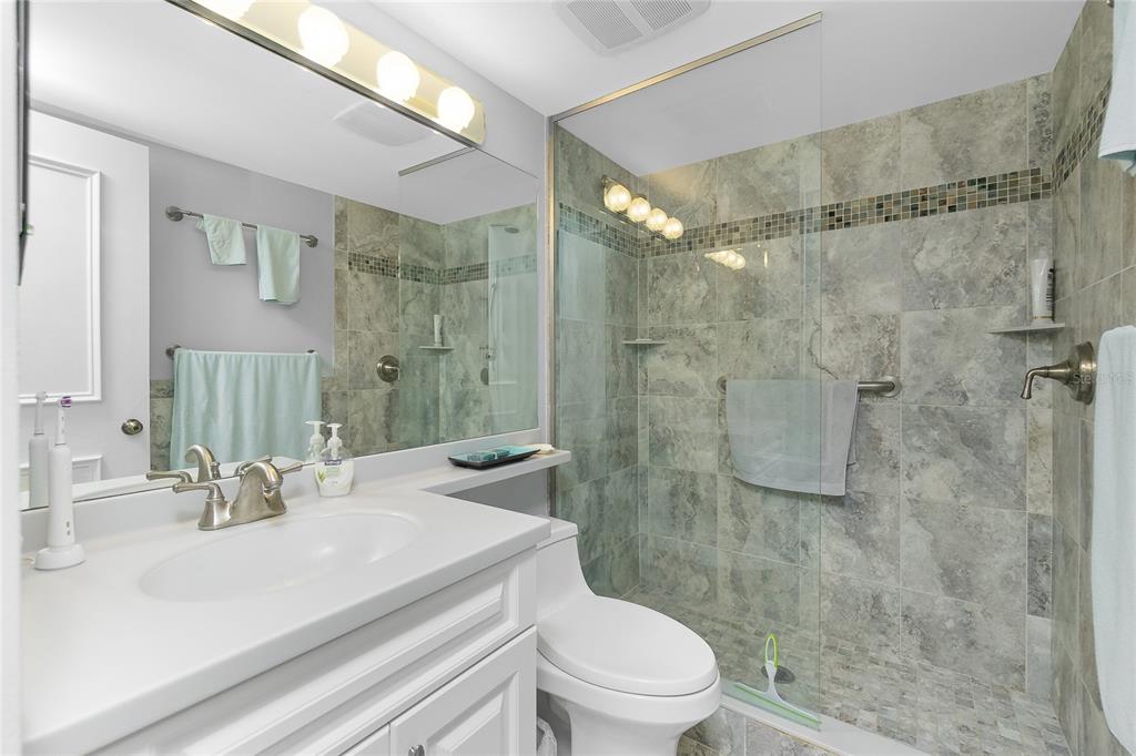1651 Beach Road, Unit 301 Englewood, FL 34223 - Photo 28 of 68 a bathroom with a sink a toilet and shower