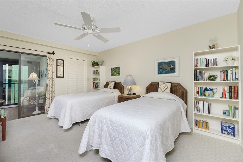 1651 Beach Road, Unit 301 Englewood, FL 34223 - Photo 30 of 68 a bedroom with two beds and a book shelf