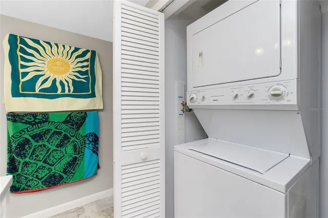 a view of a white house with a yard and potted plants