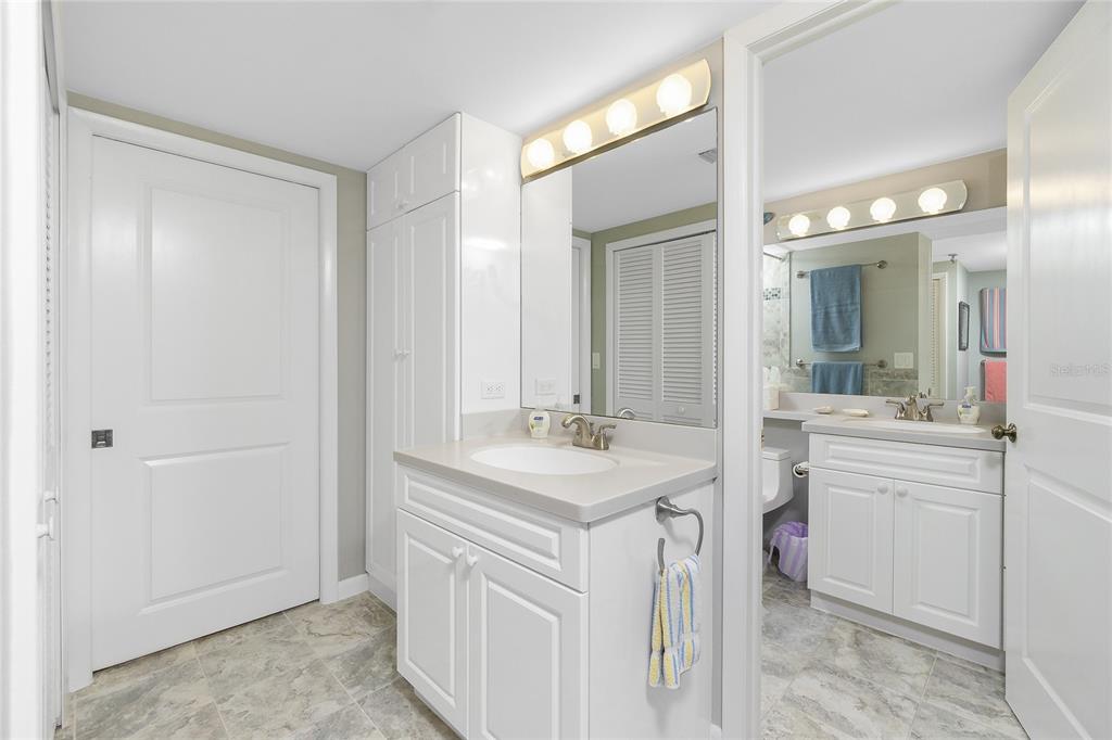1651 Beach Road, Unit 301 Englewood, FL 34223 - Photo 36 of 68 a bathroom with a sink a mirror and a vanity