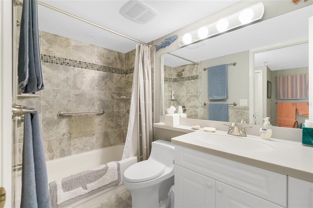 1651 Beach Road, Unit 301 Englewood, FL 34223 - Photo 37 of 68 a bathroom with a sink toilet and shower