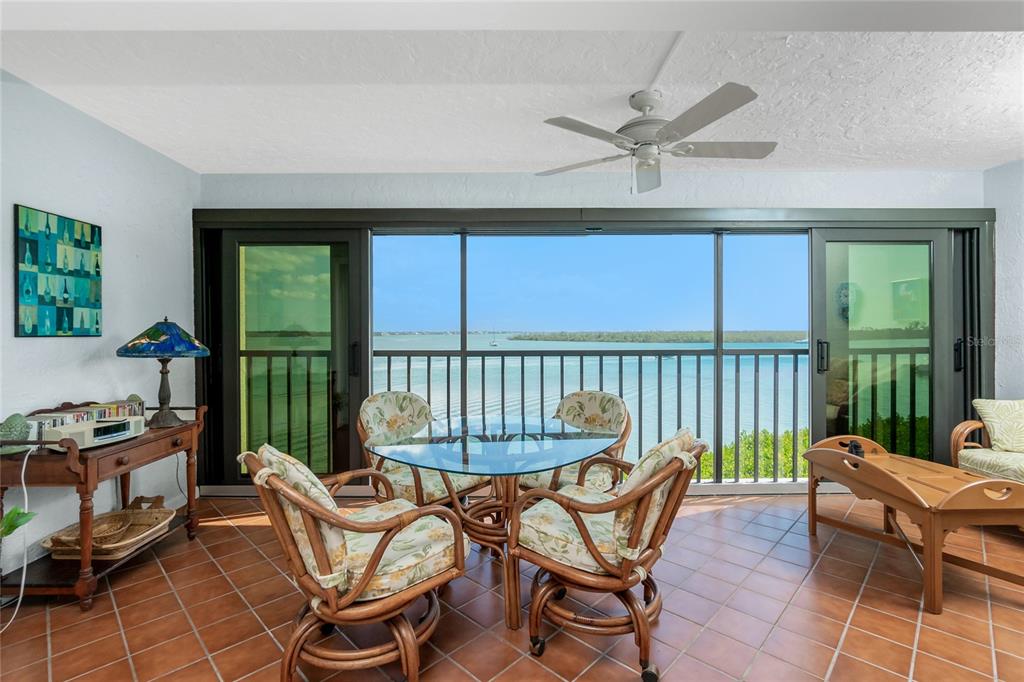 1651 Beach Road, Unit 301 Englewood, FL 34223 - Photo 7 of 68 a dining room with furniture a chandelier and a rug