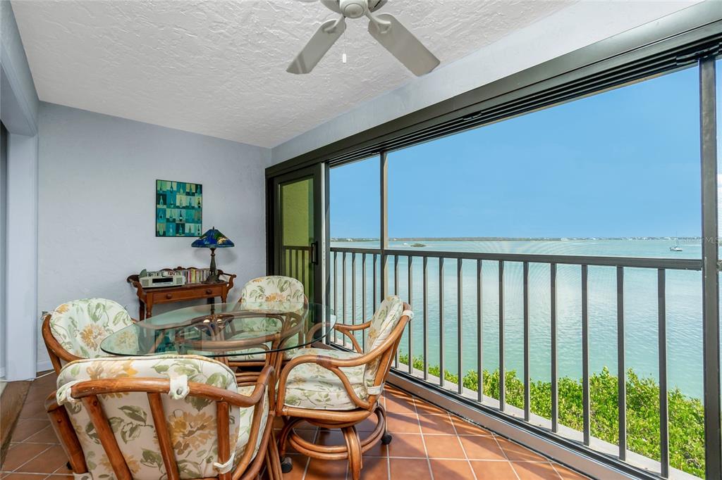 1651 Beach Road, Unit 301 Englewood, FL 34223 - Photo 10 of 68 a dining room with furniture a rug and a large window