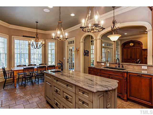 2429 Trenton Woods Way Raleigh, NC 27607 - Photo 8 of 25 Kitchen open to family room. Beautiful arches & designed ceiling paint.