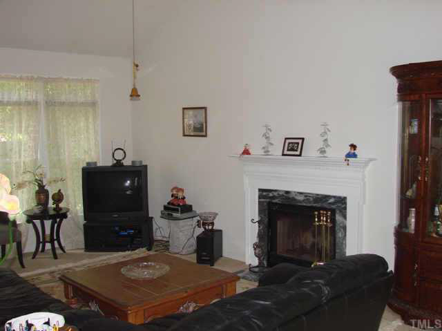 202 Kingsmill Road Cary, NC 27511 - Photo 2 of 8 a living room with a fireplace