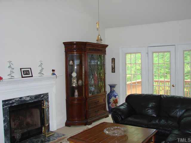 202 Kingsmill Road Cary, NC 27511 - Photo 3 of 8 a living room with furniture and a fireplace