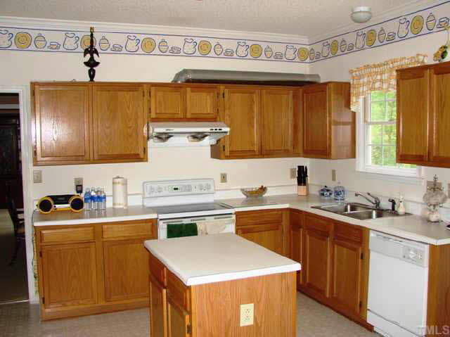 202 Kingsmill Road Cary, NC 27511 - Photo 5 of 8 a kitchen with a sink a stove and cabinets