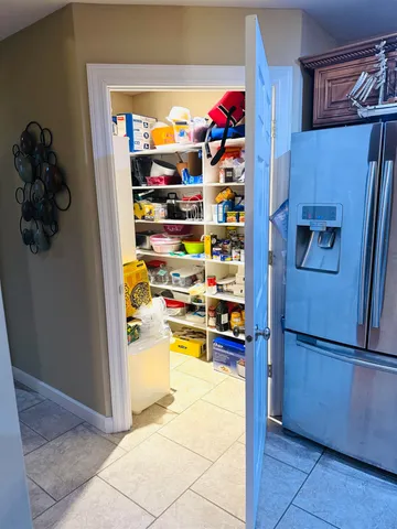 a kitchen with refrigerator and cabinets