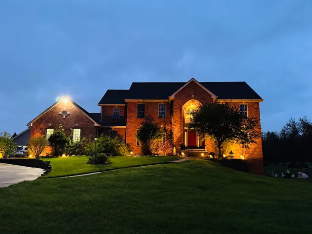 a backyard of a house with lots of green space and outdoor seating
