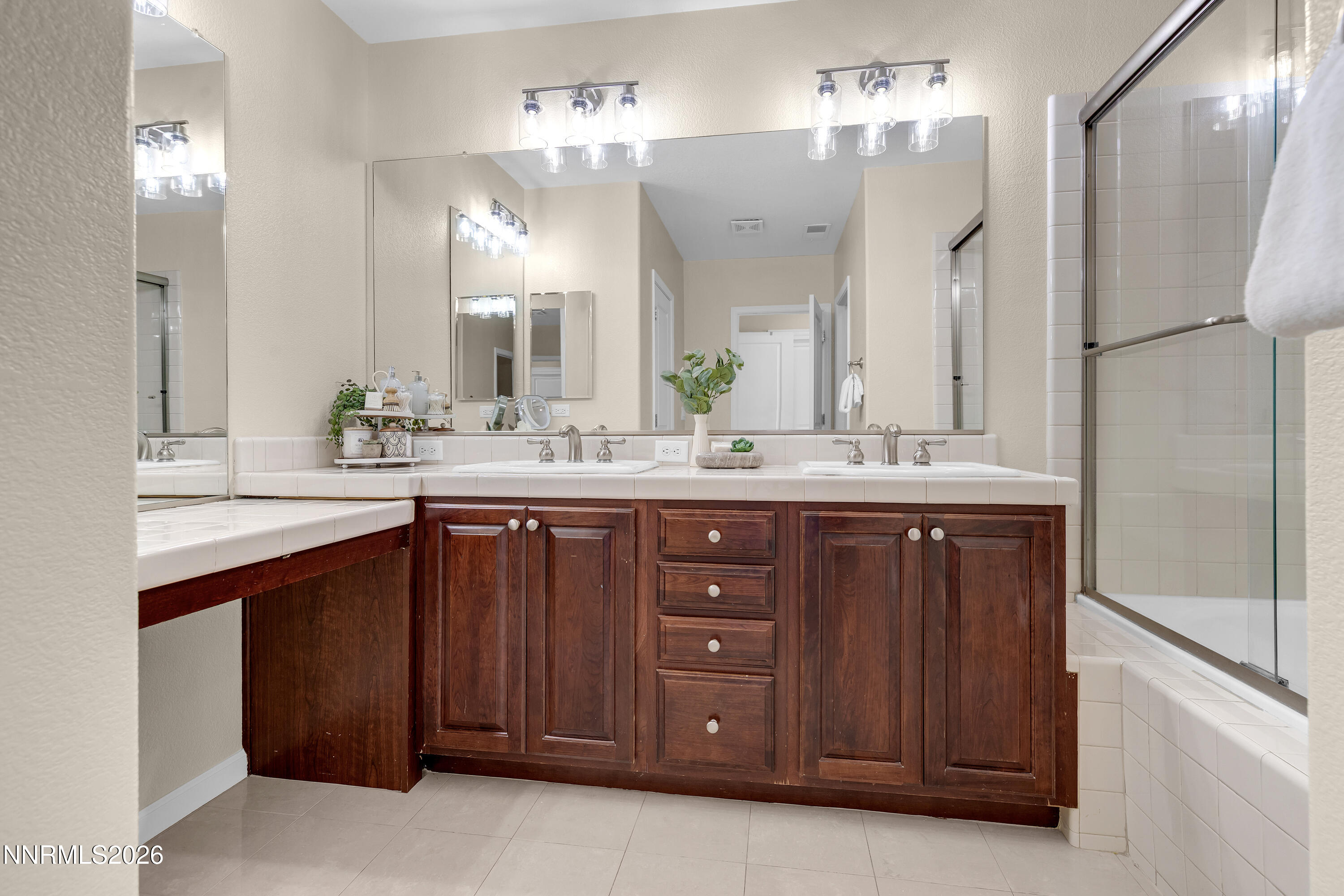 1642 Spring Hill Drive Reno, NV 89523 - Photo 19 of 43 a bathroom with a granite countertop sink a mirror and a shower