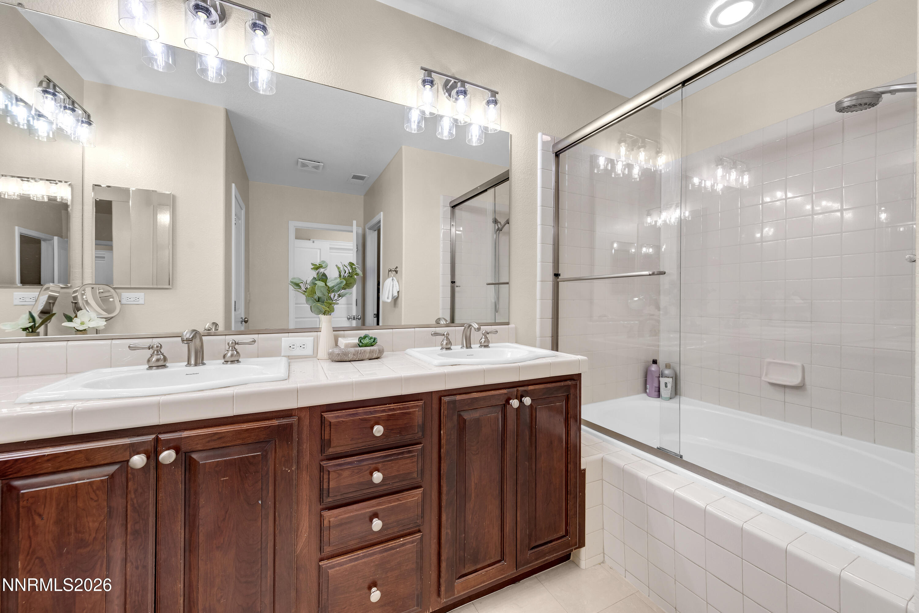 1642 Spring Hill Drive Reno, NV 89523 - Photo 20 of 43 a bathroom with a granite countertop sink mirror and a bath tub