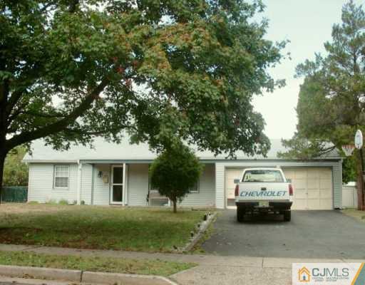 12 Tamarack Road Somerset, NJ 08873 - Photo 1 of 1 a car parked in front of a white house