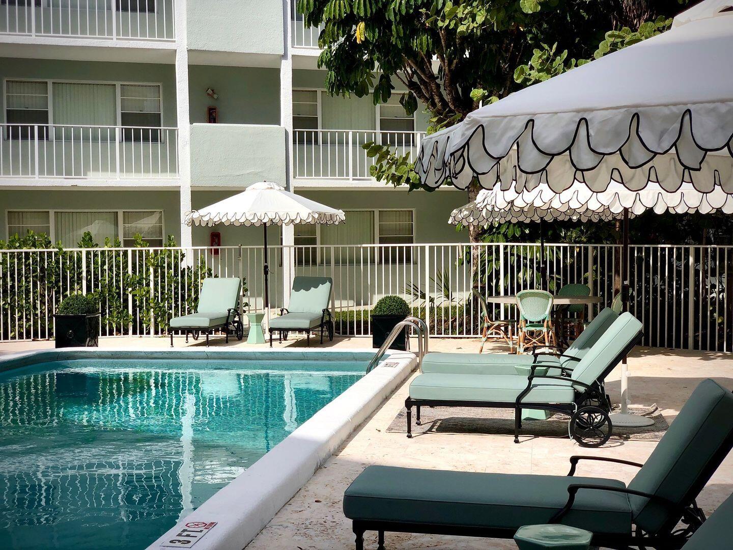 2711 Vandiver Drive, Unit 307 West Palm Beach, FL 33409 - Photo 11 of 15 a view of a chair and tables on the deck