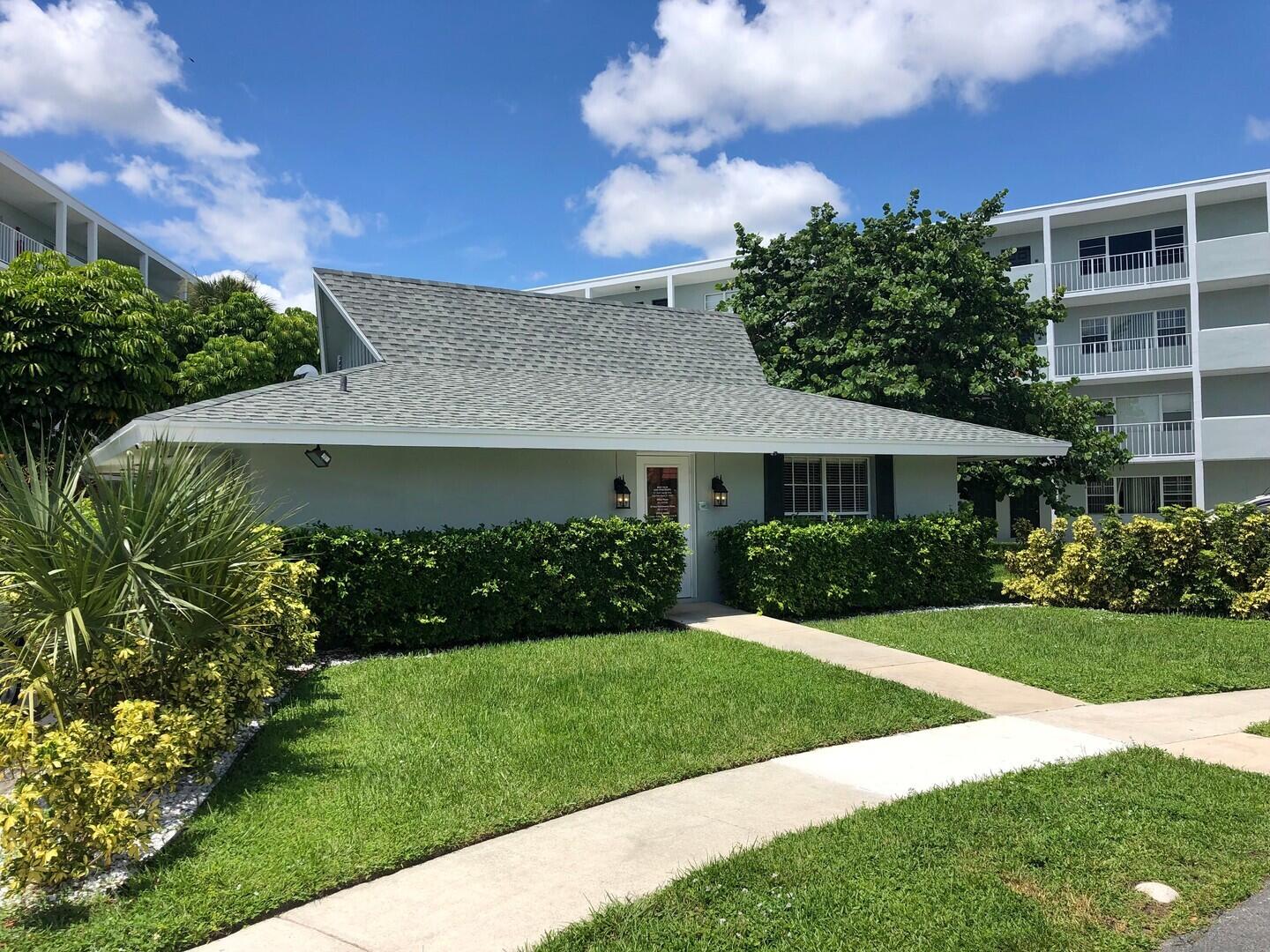 2711 Vandiver Drive, Unit 307 West Palm Beach, FL 33409 - Photo 13 of 15 a front view of a house with a yard