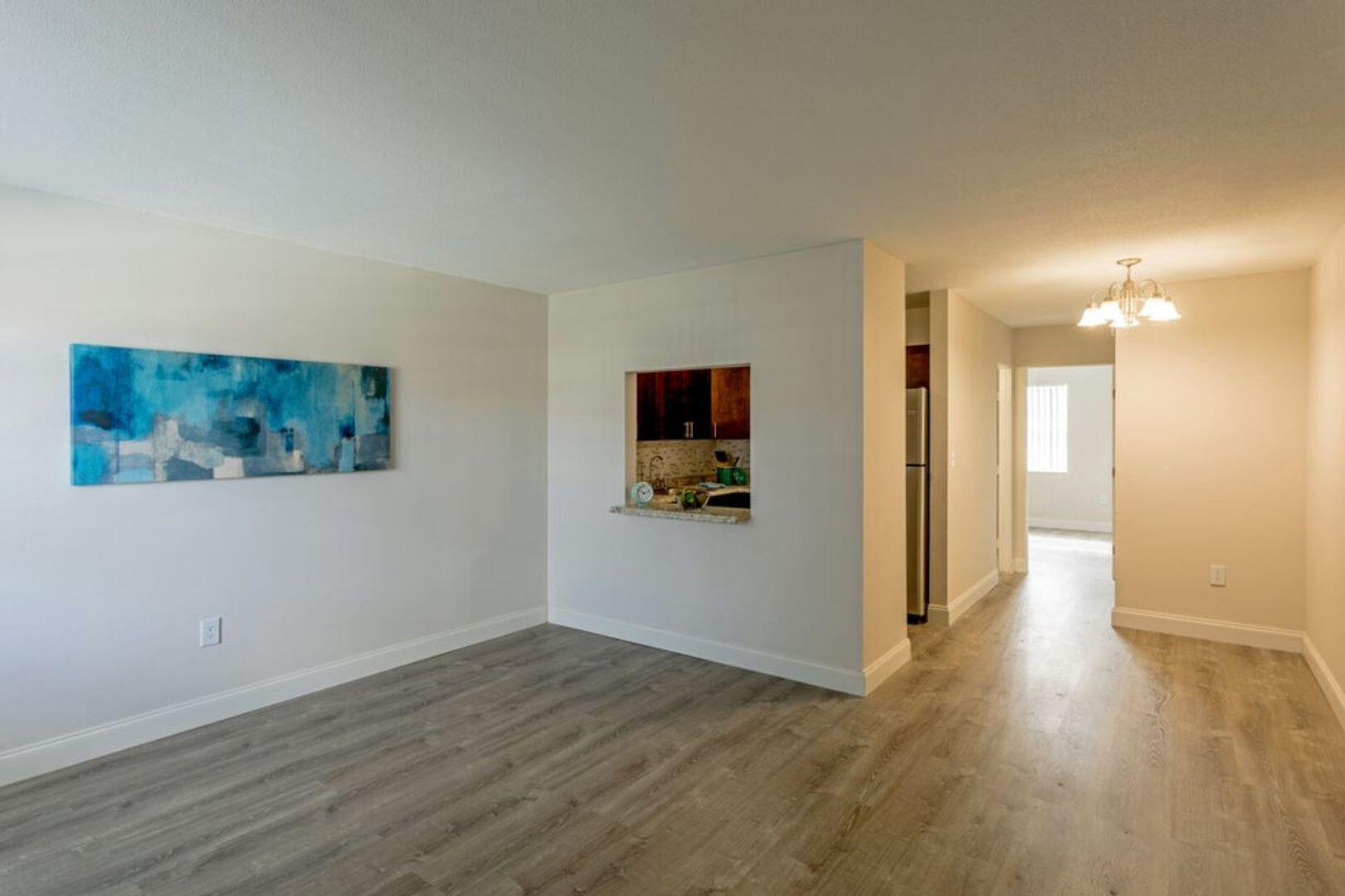 2711 Vandiver Drive, Unit 307 West Palm Beach, FL 33409 - Photo 3 of 15 a view of a hallway with wooden floor and chair in a room