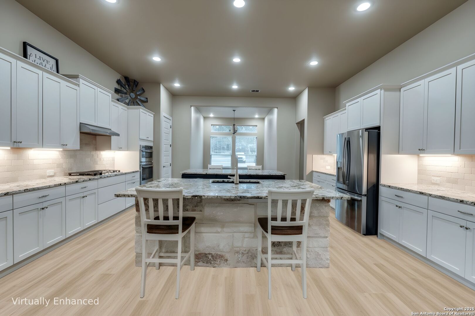 629 Windmill Ranch Road Spring Branch, TX 78070 - Photo 13 of 34 a kitchen with a table chairs wooden cabinets and stainless steel appliances