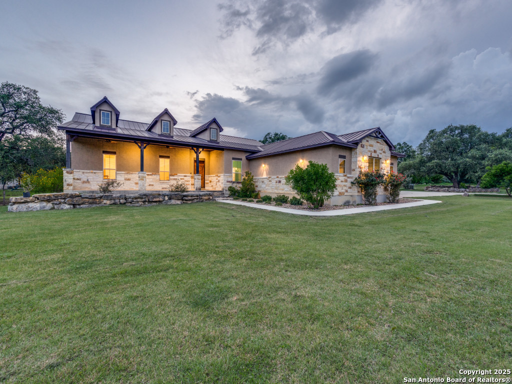 629 Windmill Ranch Road Spring Branch, TX 78070 - Photo 2 of 34 a view of house with a big yard and potted plants