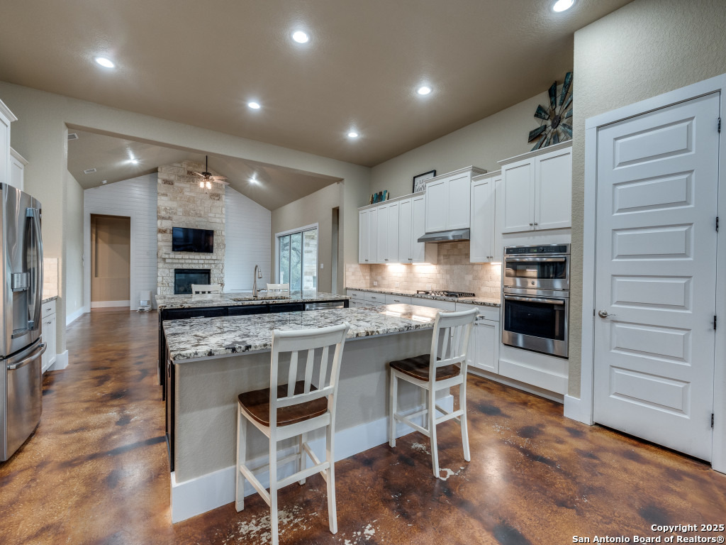 629 Windmill Ranch Road Spring Branch, TX 78070 - Photo 8 of 34 a kitchen with kitchen island a counter top space appliances and cabinets