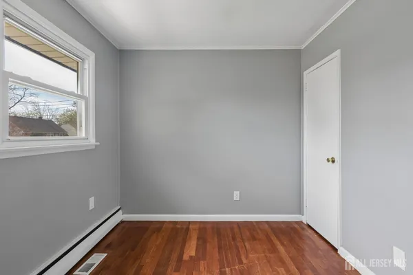 a view of a room with wooden floor and window
