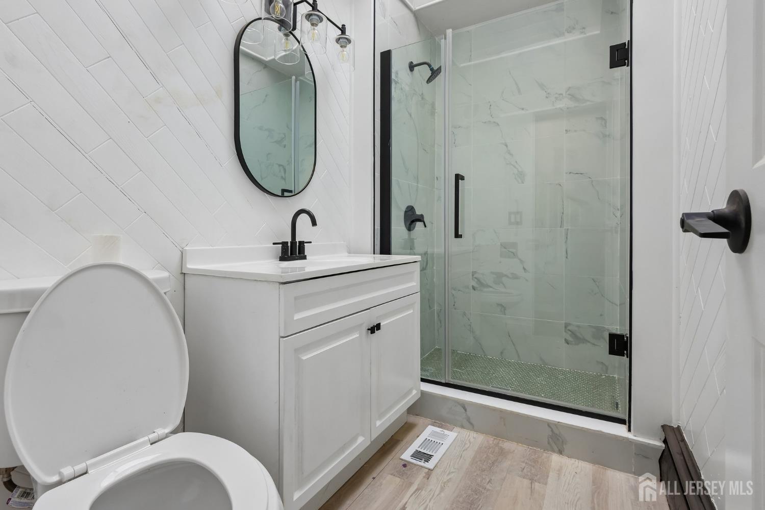2 Westbury Road Iselin, NJ 08830 - Photo 14 of 25 a bathroom with a toilet sink and shower