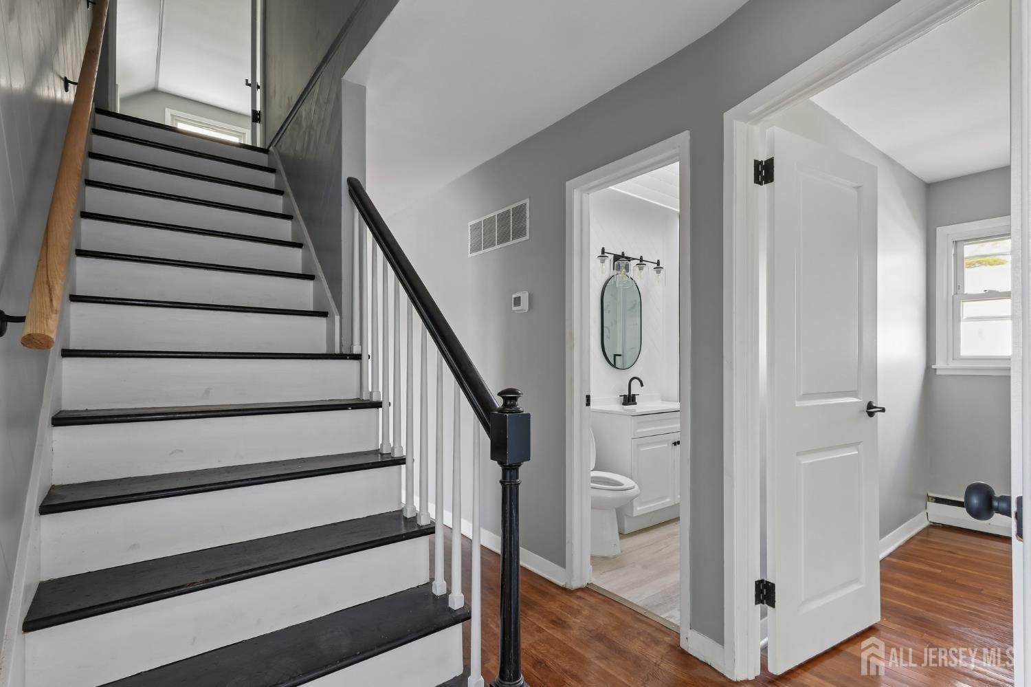 2 Westbury Road Iselin, NJ 08830 - Photo 17 of 25 a view of a hallway with wooden floor and staircase
