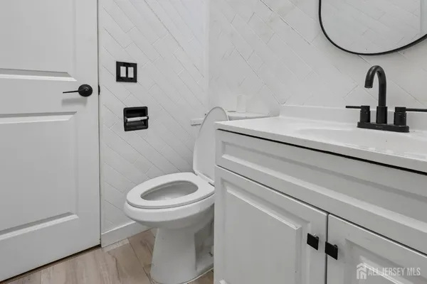 a bathroom with a sink a toilet and a mirror