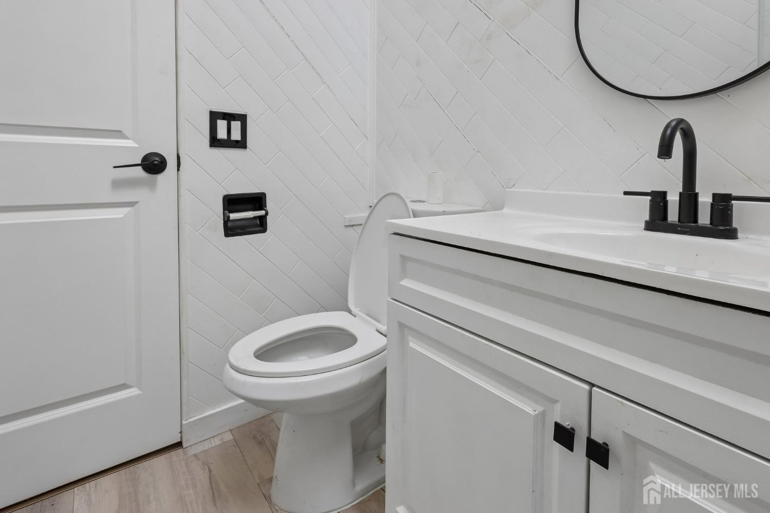 2 Westbury Road Iselin, NJ 08830 - Photo 18 of 25 a bathroom with a sink a toilet and a mirror